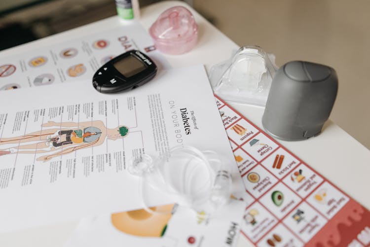 Flyers And Glucose Meter On Table