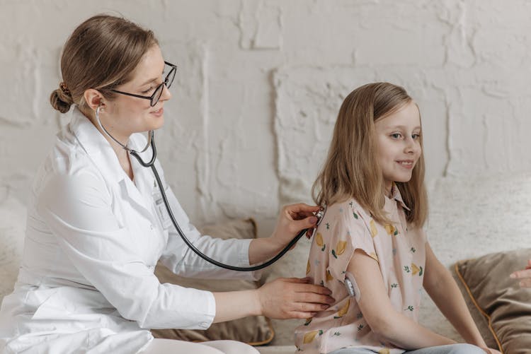 A Doctor Checking-Up The Girl Using Stethoscope