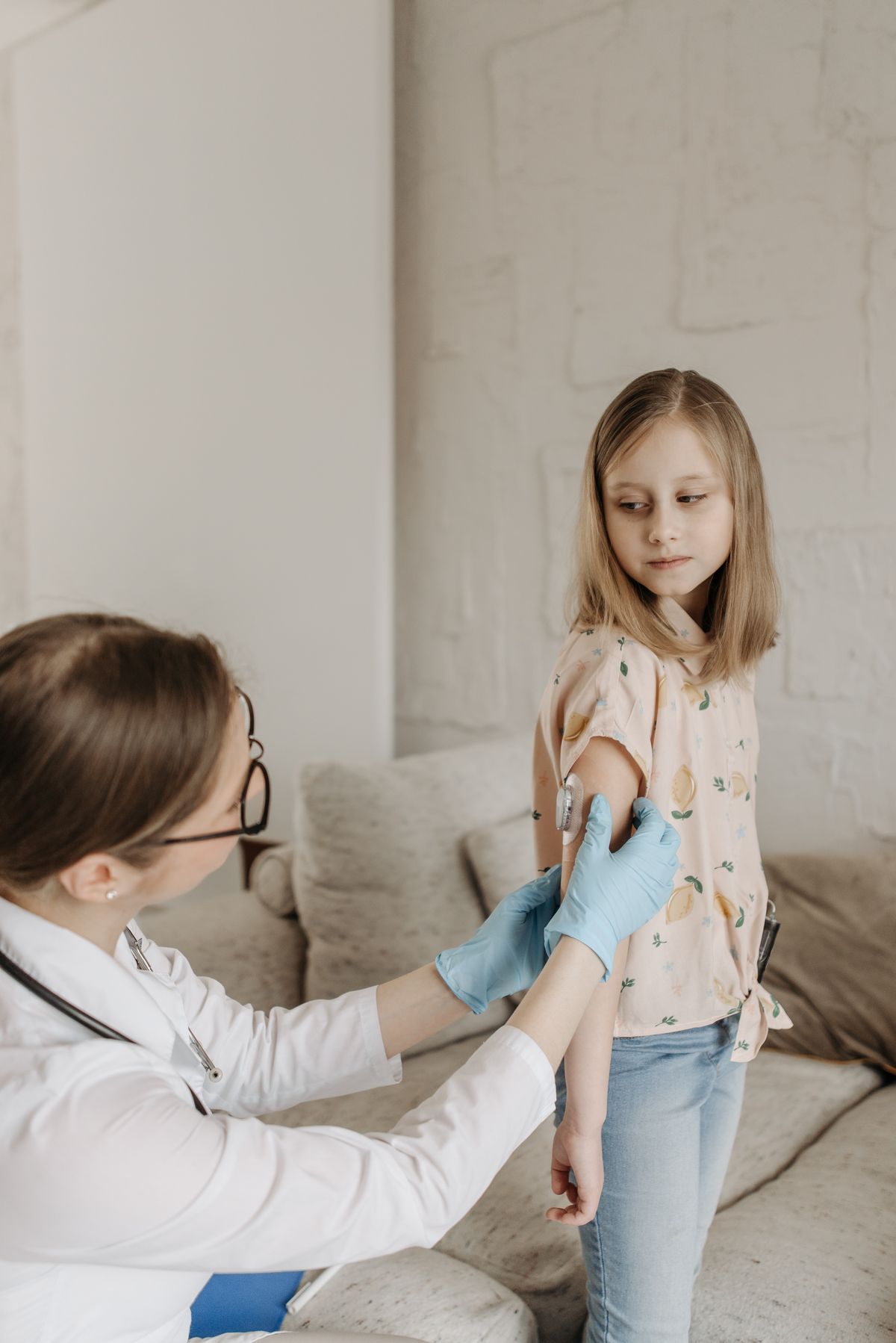 Doctor giving a childhood vaccine to a young patient in a clinic