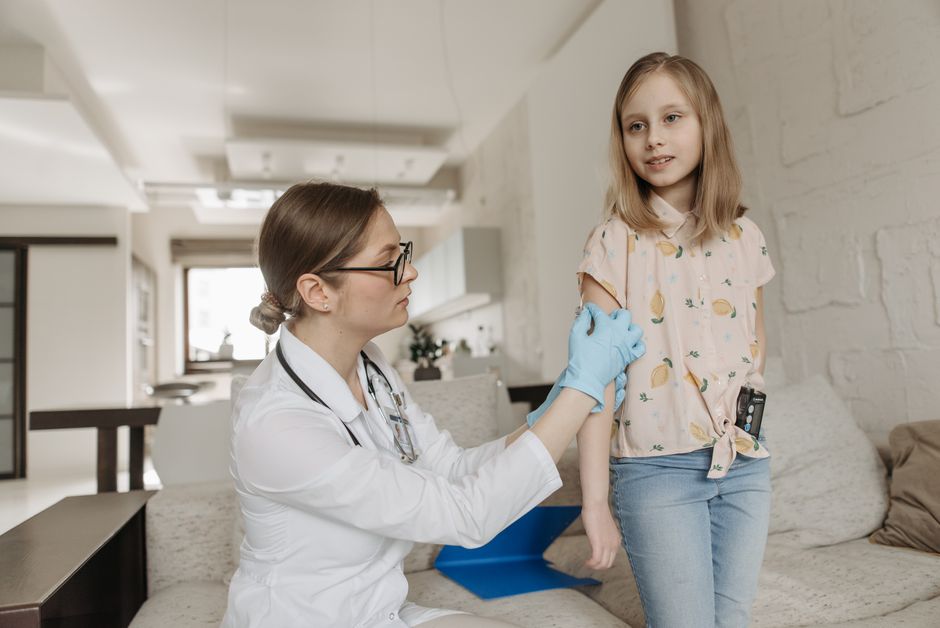 Photo by Pavel Danilyuk on Pexels A pediatrician checks a child's arm during a home visit focusing on diabetes management. - Photo by Pavel Danilyuk on Pexels