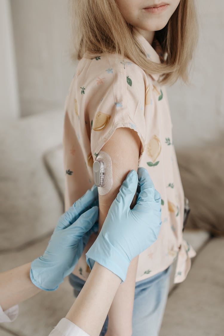 
A Continuous Glucose Monitor On A Girl's Arm