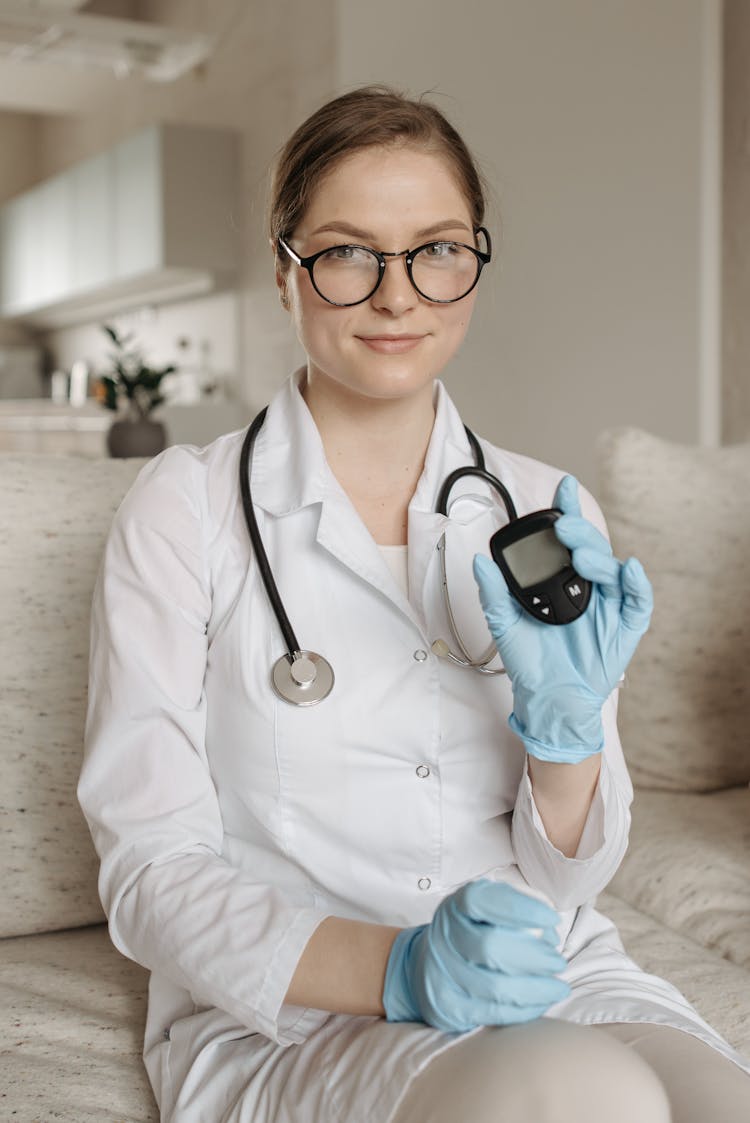 A Doctor Showing The Glucometer She Is Holding