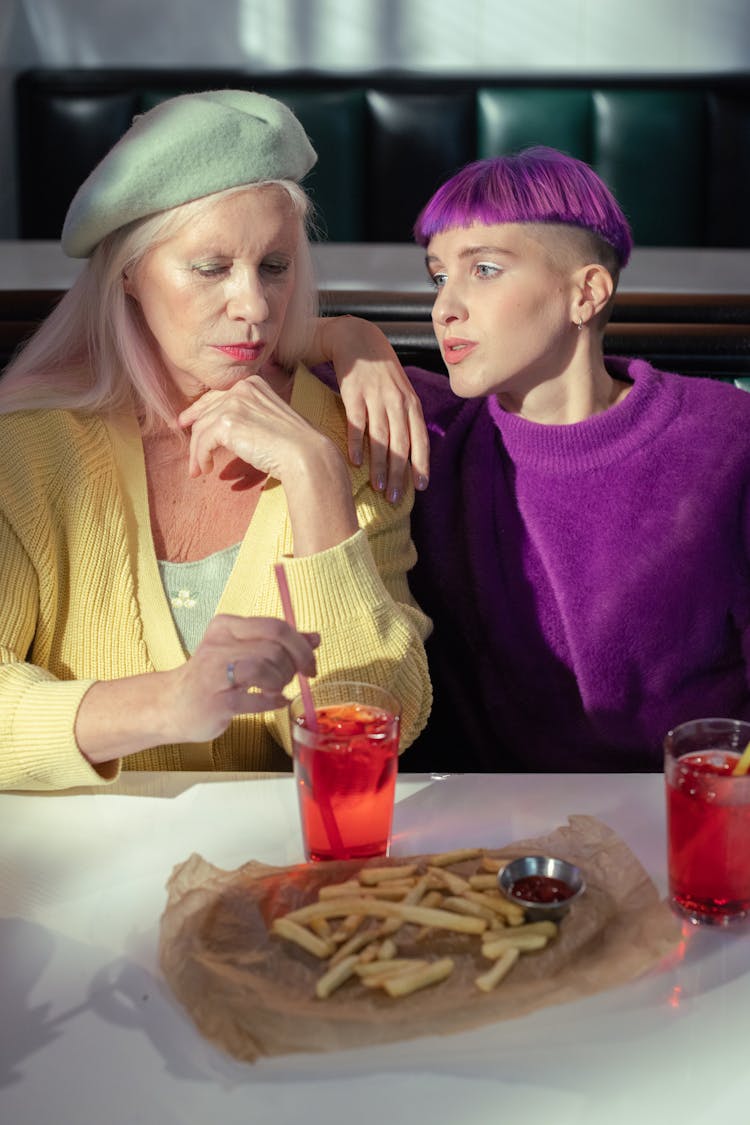 A Woman And Her Daughter At A Dining Table