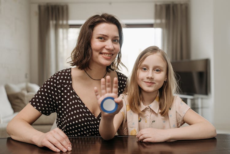 Mother And Daughter Smiling At The Camera