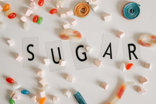 Sweets Scattered around a Text Saying "Sugar"