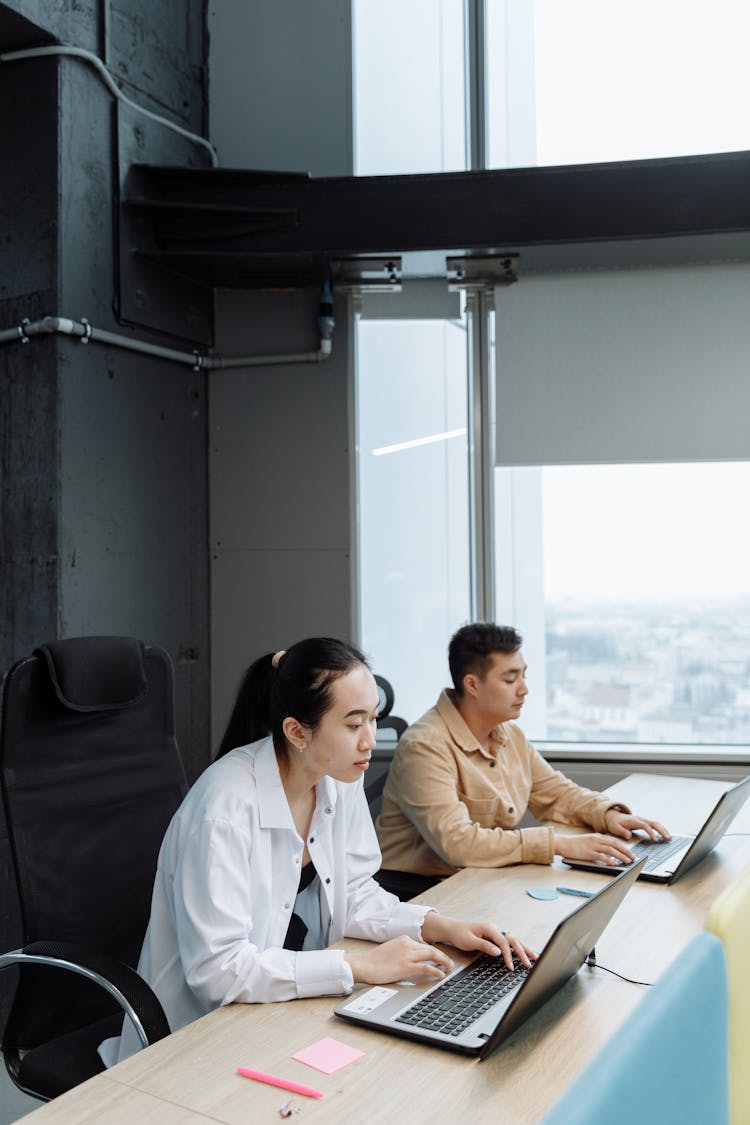 People Using Laptops In An Office