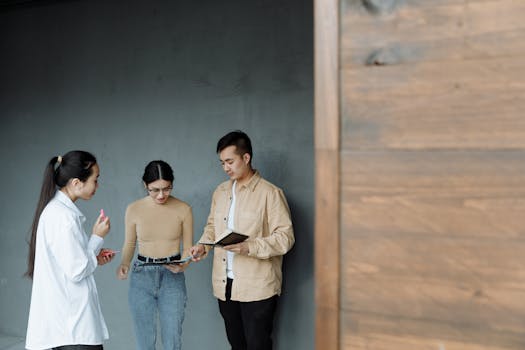 Three young adults having a professional discussion indoors.