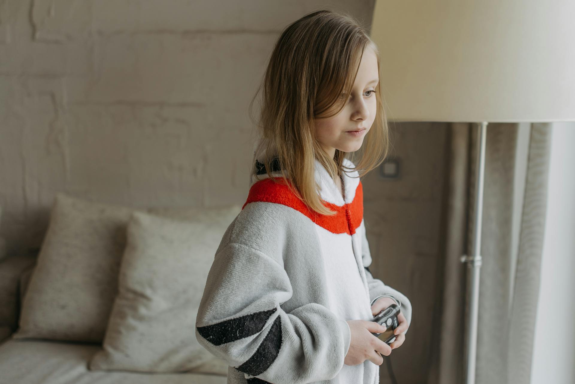 A Girl Wearing a Onesie Holding an Insulin Pump