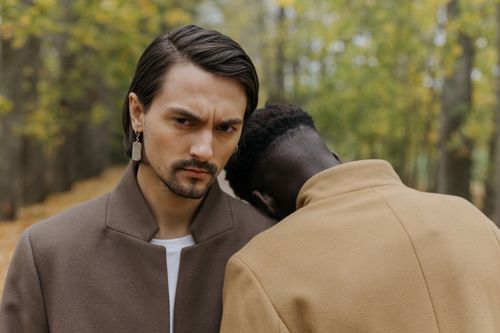Free Two men showing friendship and support in an autumn forest wearing stylish overcoats. Stock Photo