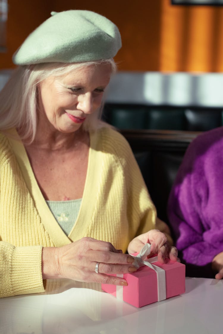 Elderly Woman Opening A Gift