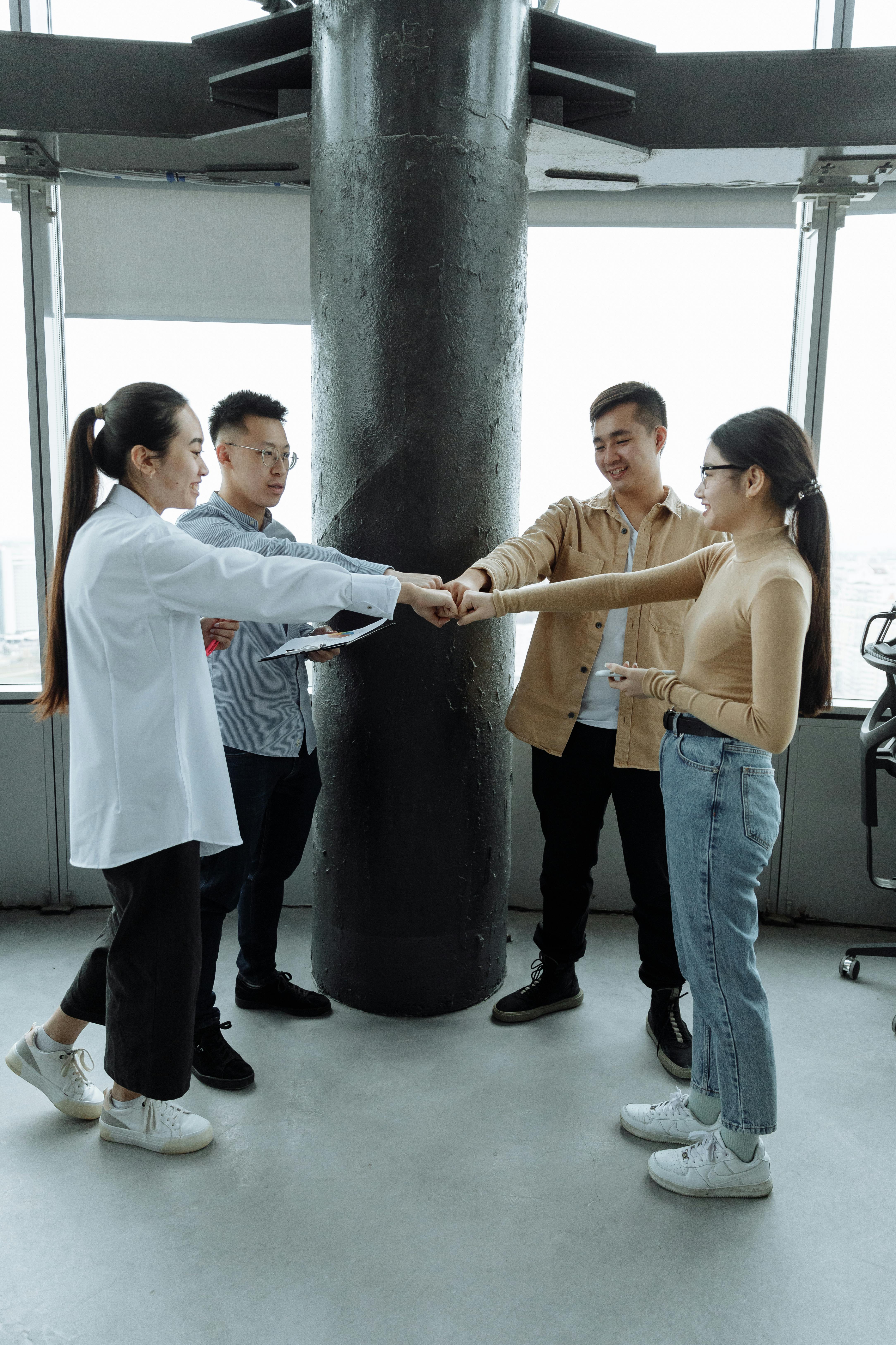 man in white dress shirt and blue denim jeans standing beside woman in yellow t shirt