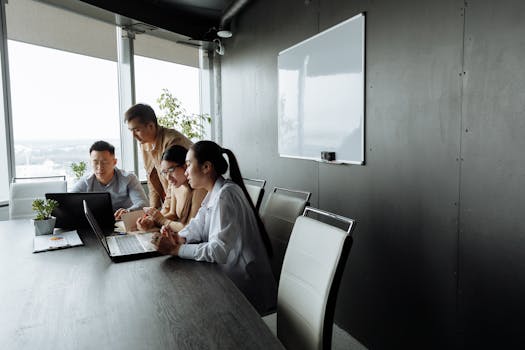 A diverse team brainstorming and collaborating on a project in a modern office setting.