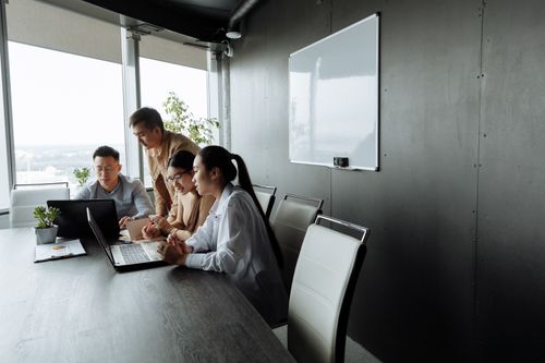Free A diverse team brainstorming and collaborating on a project in a modern office setting. Stock Photo