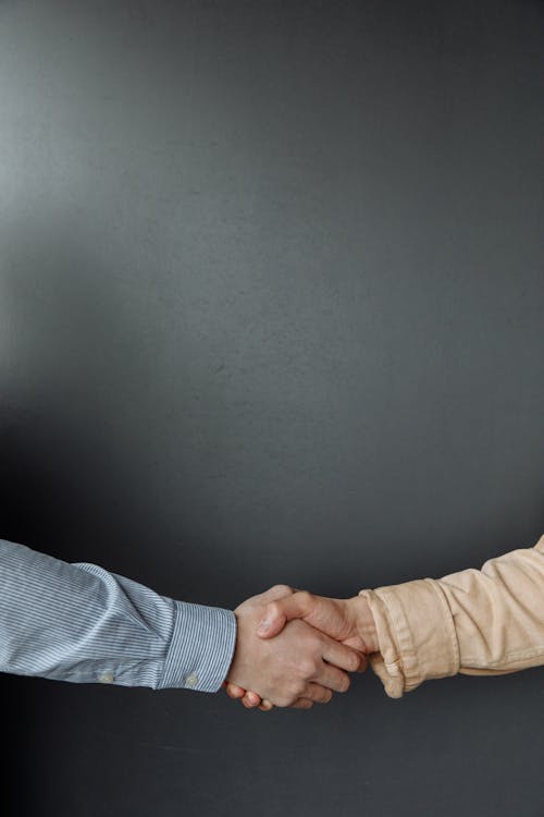 Close Up Shot of People Shaking Hands