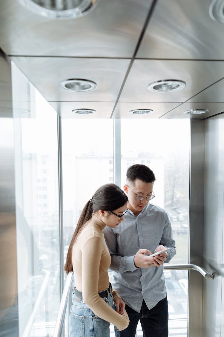 Man And Woman Inside The Elevator