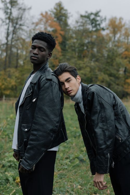 Free Two stylish men in leather jackets posing confidently in a scenic autumn setting. Stock Photo
