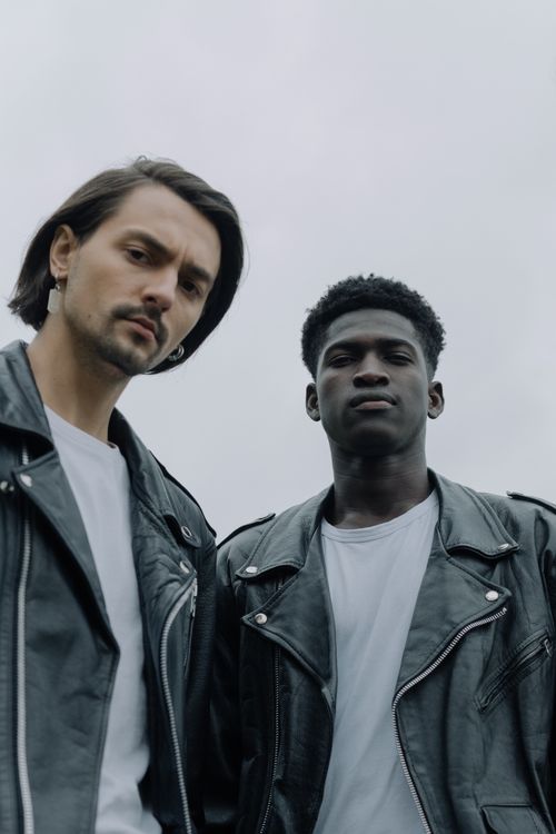 Free Stylish portrait of two men in leather jackets on a cloudy day. Stock Photo