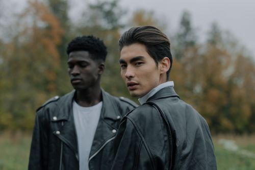 Free Two stylish men wearing leather jackets outdoors in an autumn setting. Stock Photo