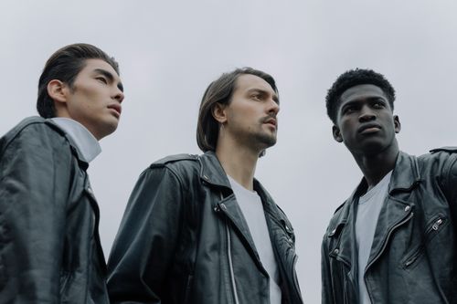 Free Three diverse men in leather jackets pose confidently outdoors. Stock Photo