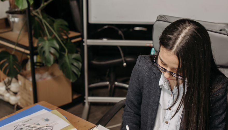 Professional reviewing plans at desk