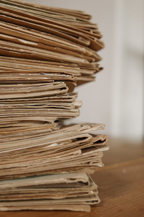Close-Up Shot of Document Folders on Wooden Surface