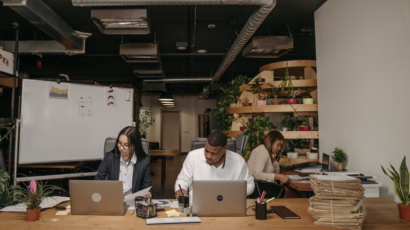 Three founders working together in a startup office