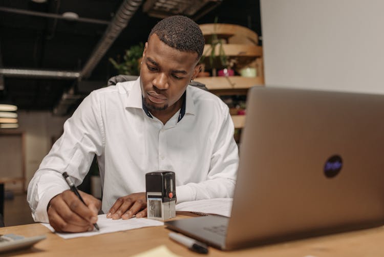 Man In White Long Sleeves Working In The Office