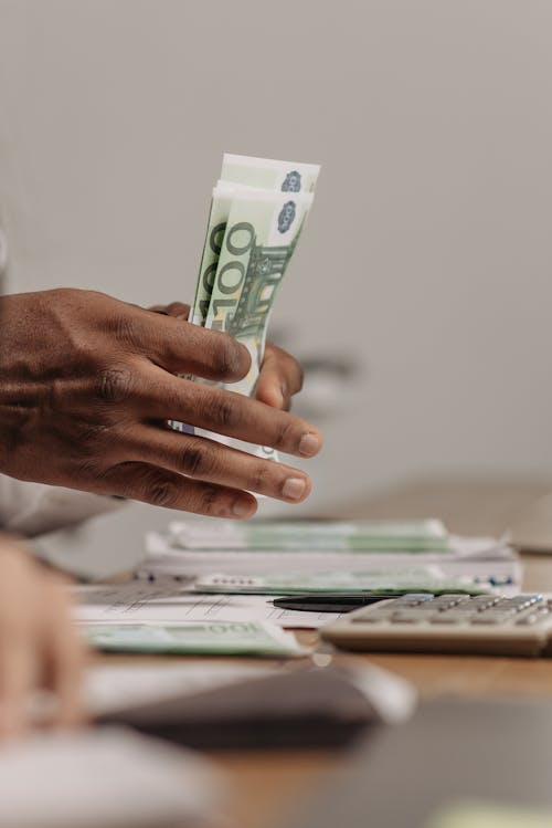 Free Close-Up Shot of a Person Counting Money Stock Photo