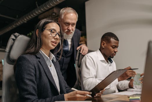 Business team working together, discussing ideas in an indoor office setting.