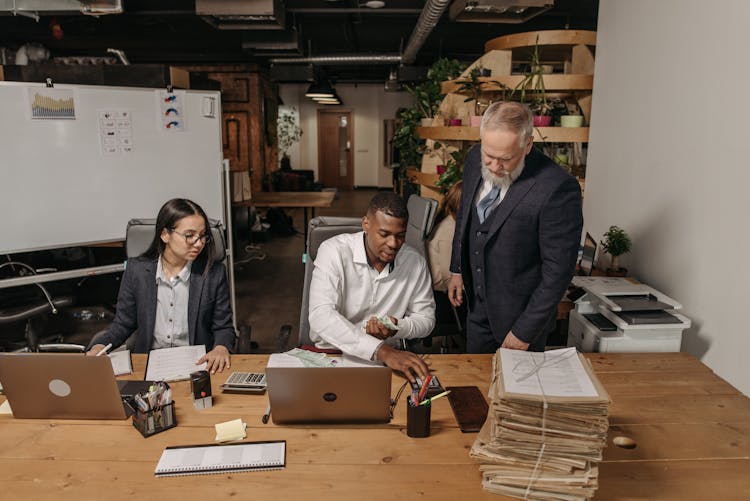 Three People Working In The Office