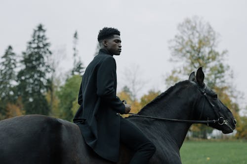 A Man Riding a Black Horse