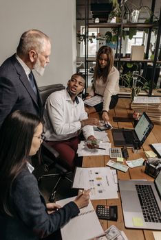 A diverse group of professionals engaging in a collaborative effort in the office.