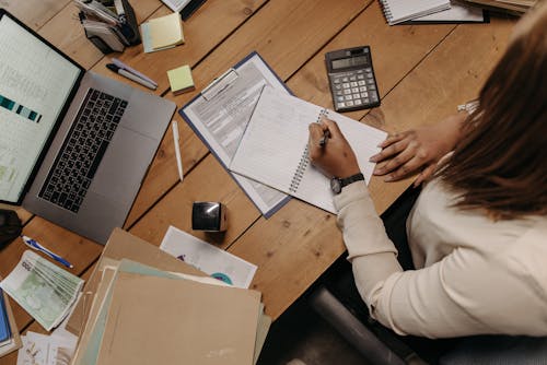 Free Person in White Long Sleeve Shirt Holding White Paper Stock Photo