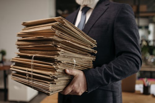 Close-Up Shot of a Person Carrying Document Folders