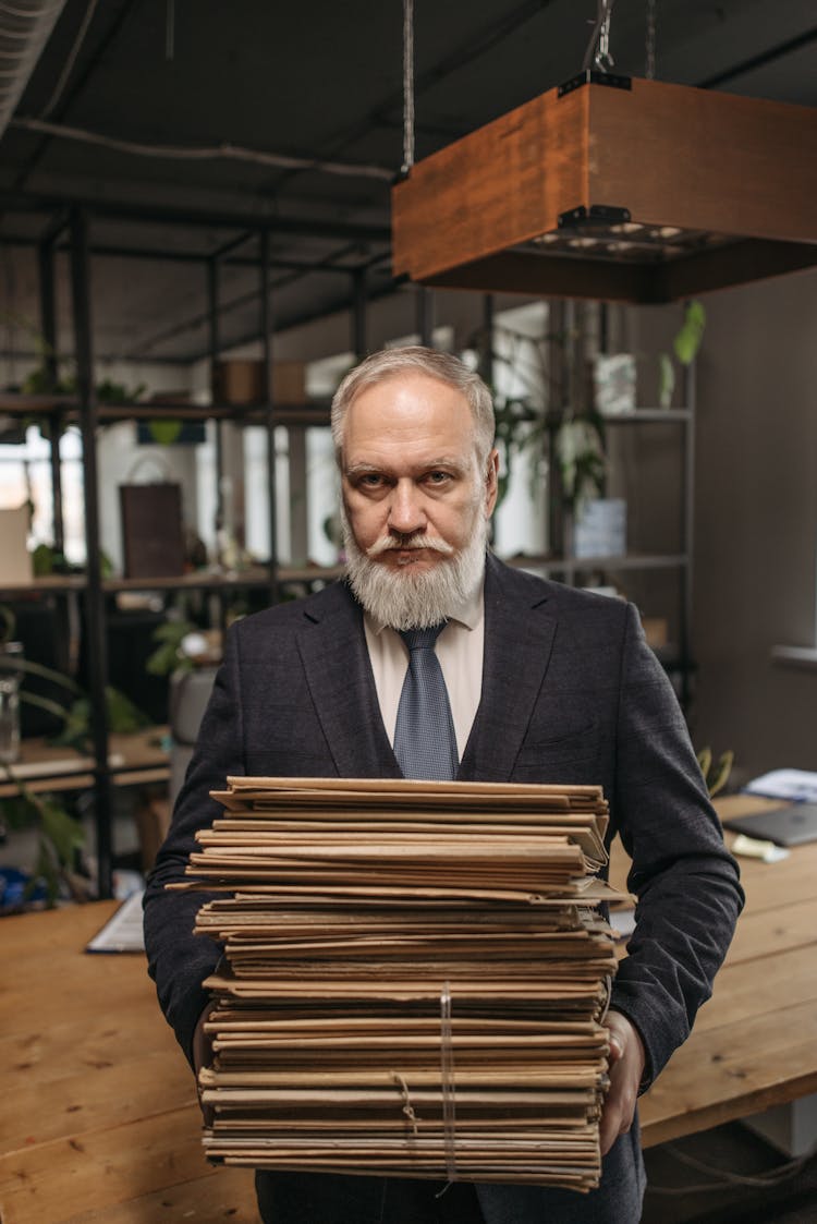 Elderly Man In Black Suit Carrying Document Folders