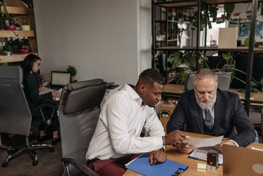 Man in White Dress Shirt Sitting on Black Office Rolling Chair