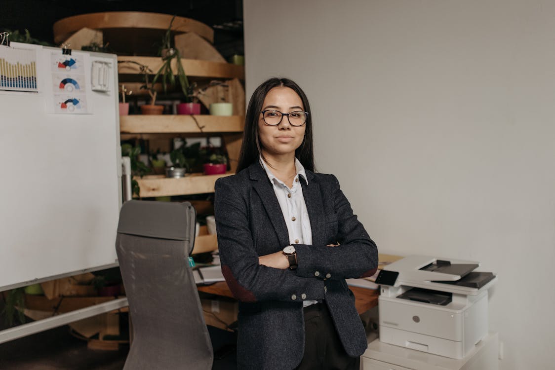 Woman in Gray Blazer Standing in the Office