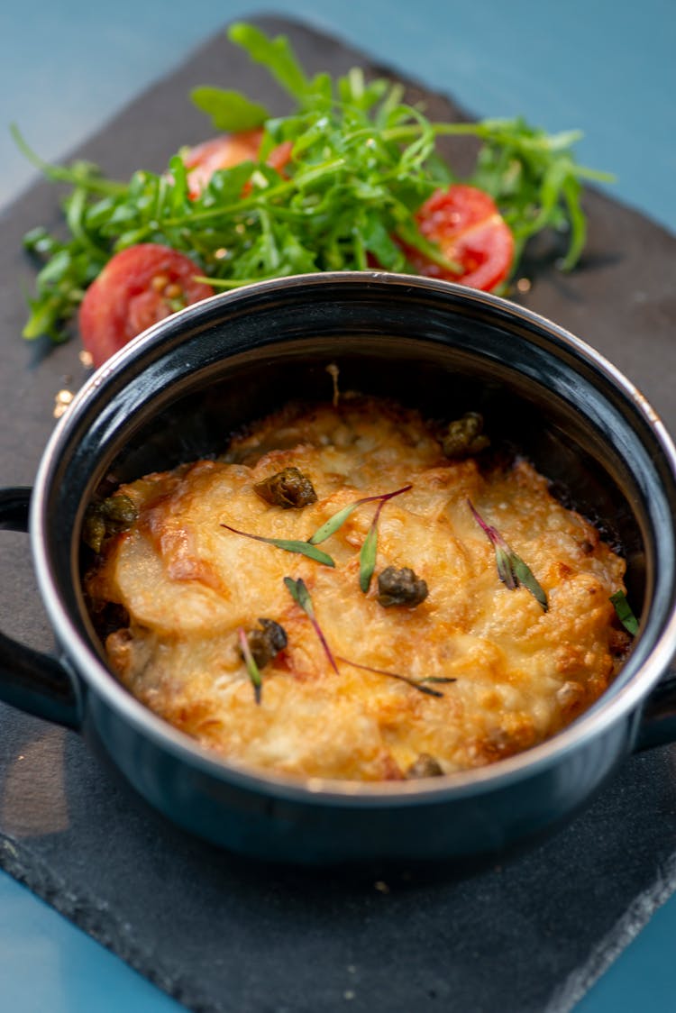 Casserole With Arugula And Tomatoes On The Side 