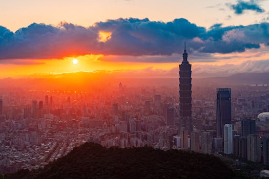 Stunning sunrise over Taipei cityscape with iconic Taipei 101 building standing tall.