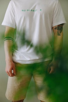 Man wearing a 'No Planet B' t-shirt surrounded by greenery, promoting eco-awareness.