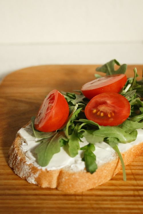 Free A fresh vegetable sandwich with arugula and tomato slices on a wooden board. Stock Photo