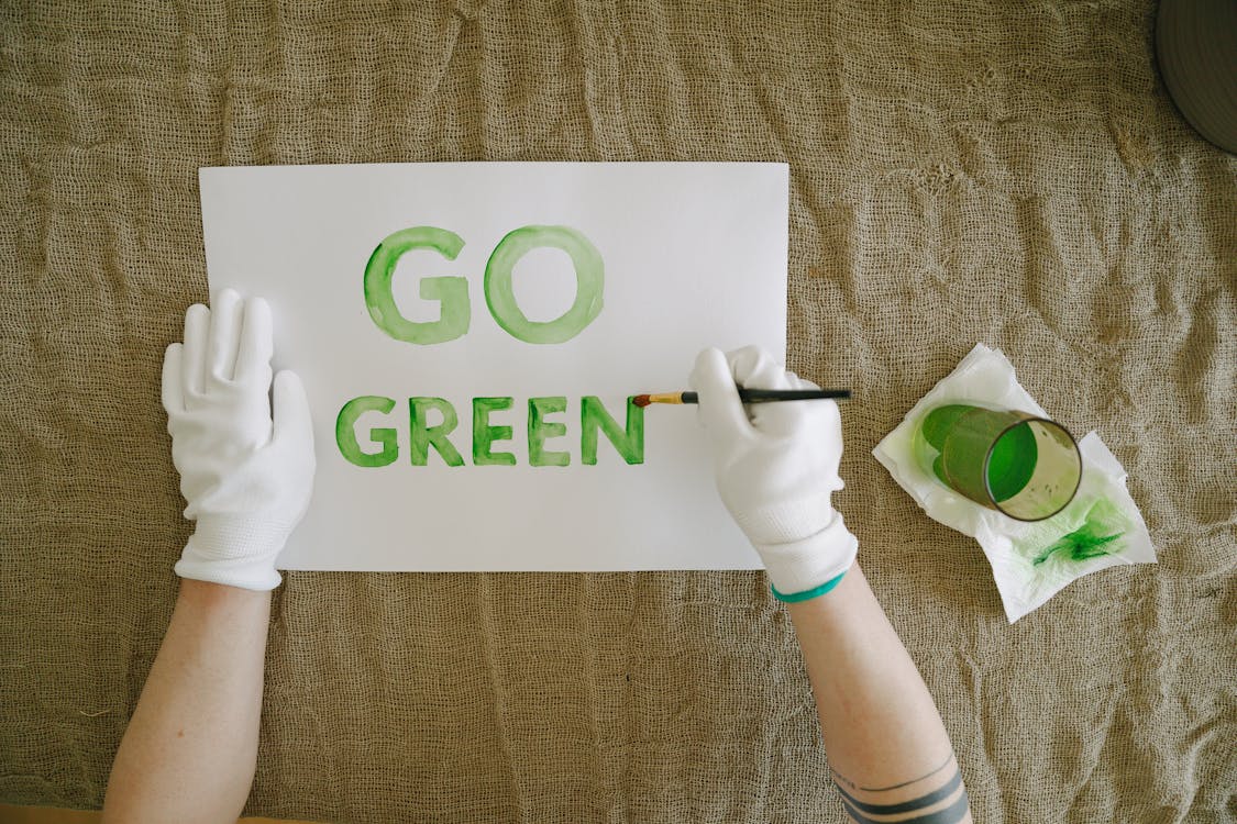 Free Person Painting Go Green on a Poster Stock Photo