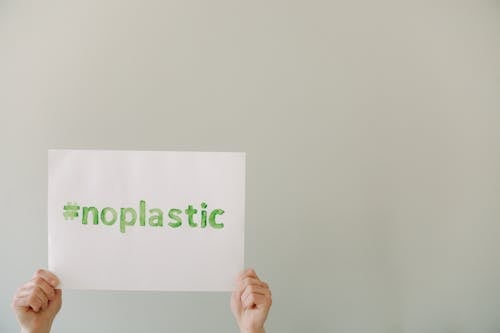 Free Person Holding a Slogan with No Plastic Text Stock Photo