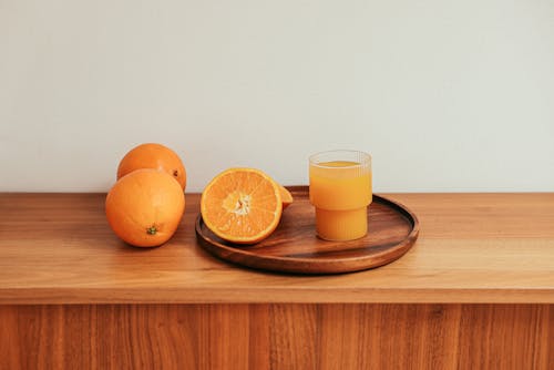 A Fresh Orange Juice on a Brown Wooden Table