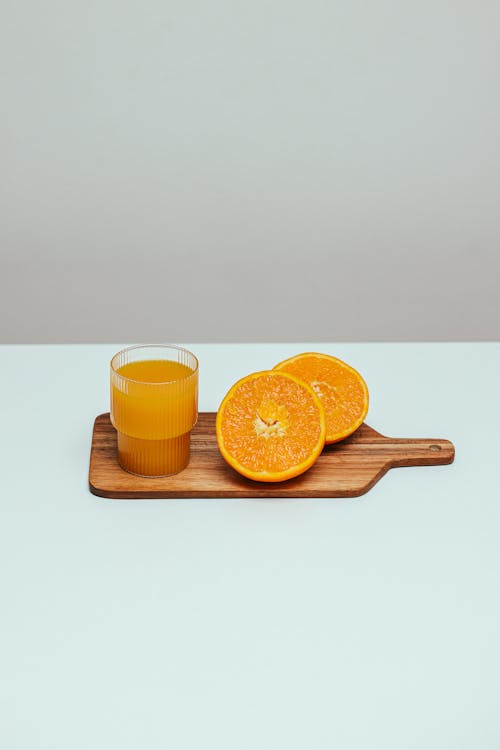 A Fresh Orange Juice on a Wooden Chopping Board