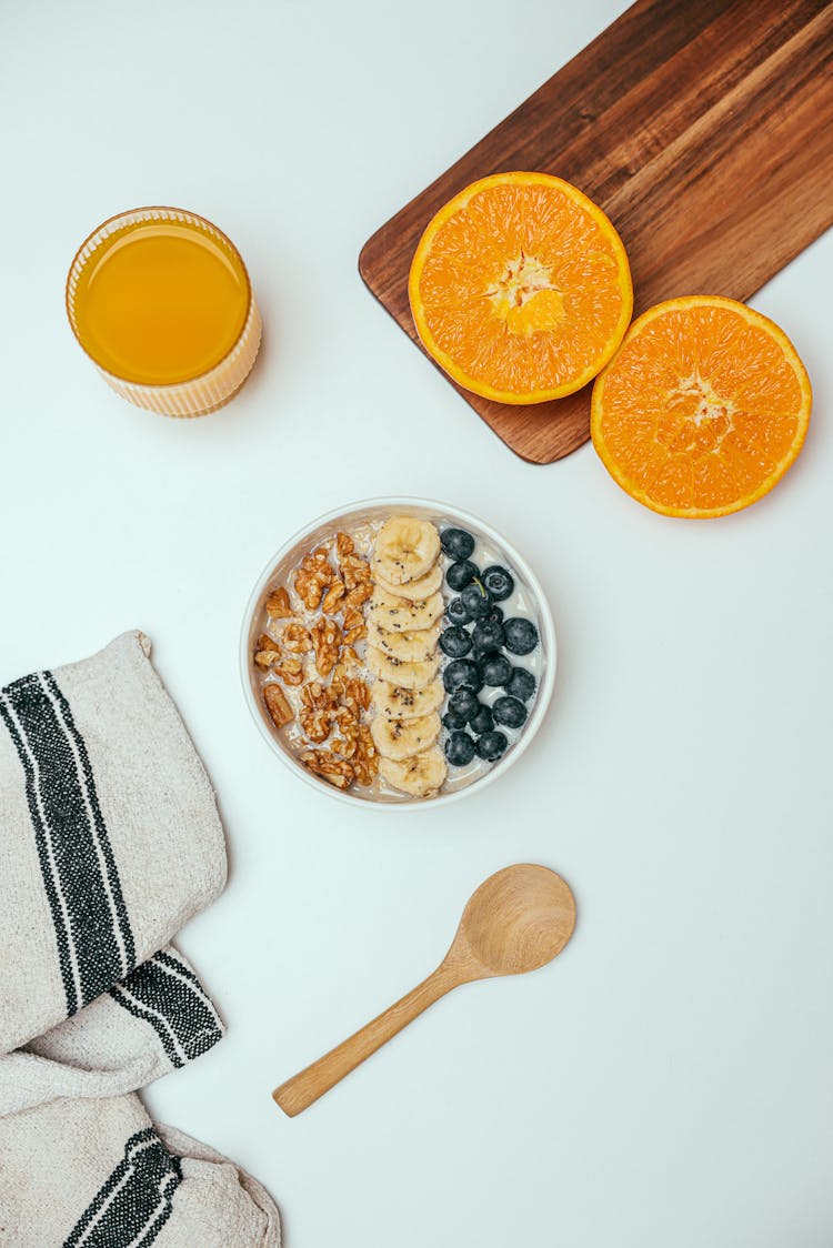 Meal In Bowl Near Juice And Orange Slices