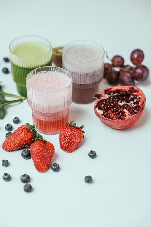 Different Fruit Juices on Clear Drinking Glass 