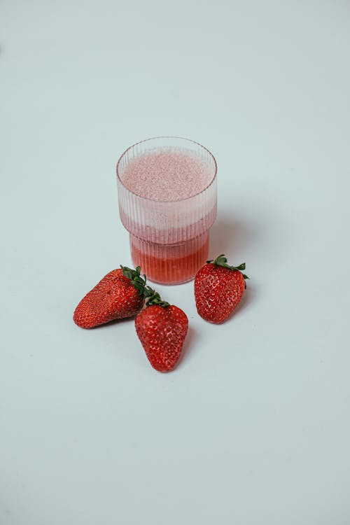 Photo of Strawberries Near a Strawberry Smoothie