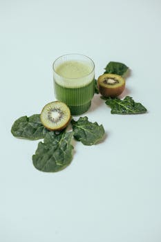A vibrant green smoothie with kiwi and spinach, offering a healthy and refreshing drink option.