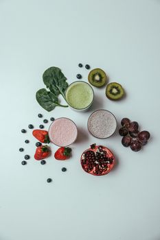 Vibrant flatlay featuring fresh fruits, leafy greens, and smoothies for a healthy lifestyle.